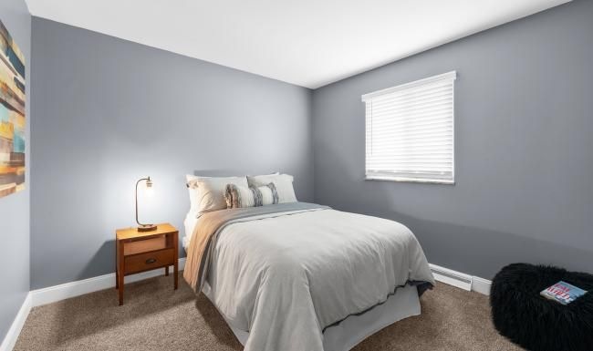 a bedroom with a bed and a lamp