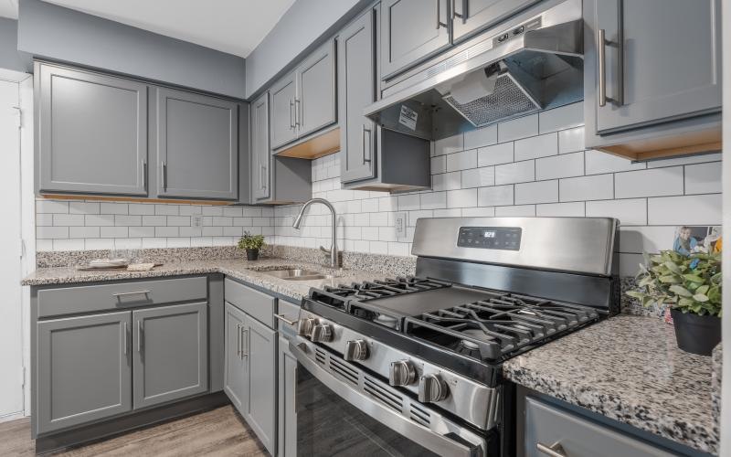 a kitchen with grey cabinets