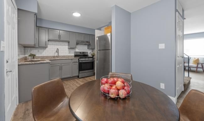 a kitchen with a table and chairs